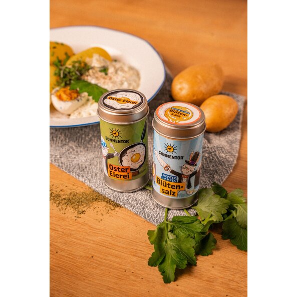 Happy Easter Herbs Spice Blend next to Bunny Rabbit's Blossom Salt as well as boiled eggs, potatoes and herbs