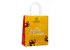 In the photo you can see a yellow paper tote bag with the inscription Ich schenke dir Freude.