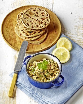 Auf dem Foto sind Dinkel-Gewürz Chapatis zu sehen. Davor steht eine Schale mit Dip. | © SONNENTOR